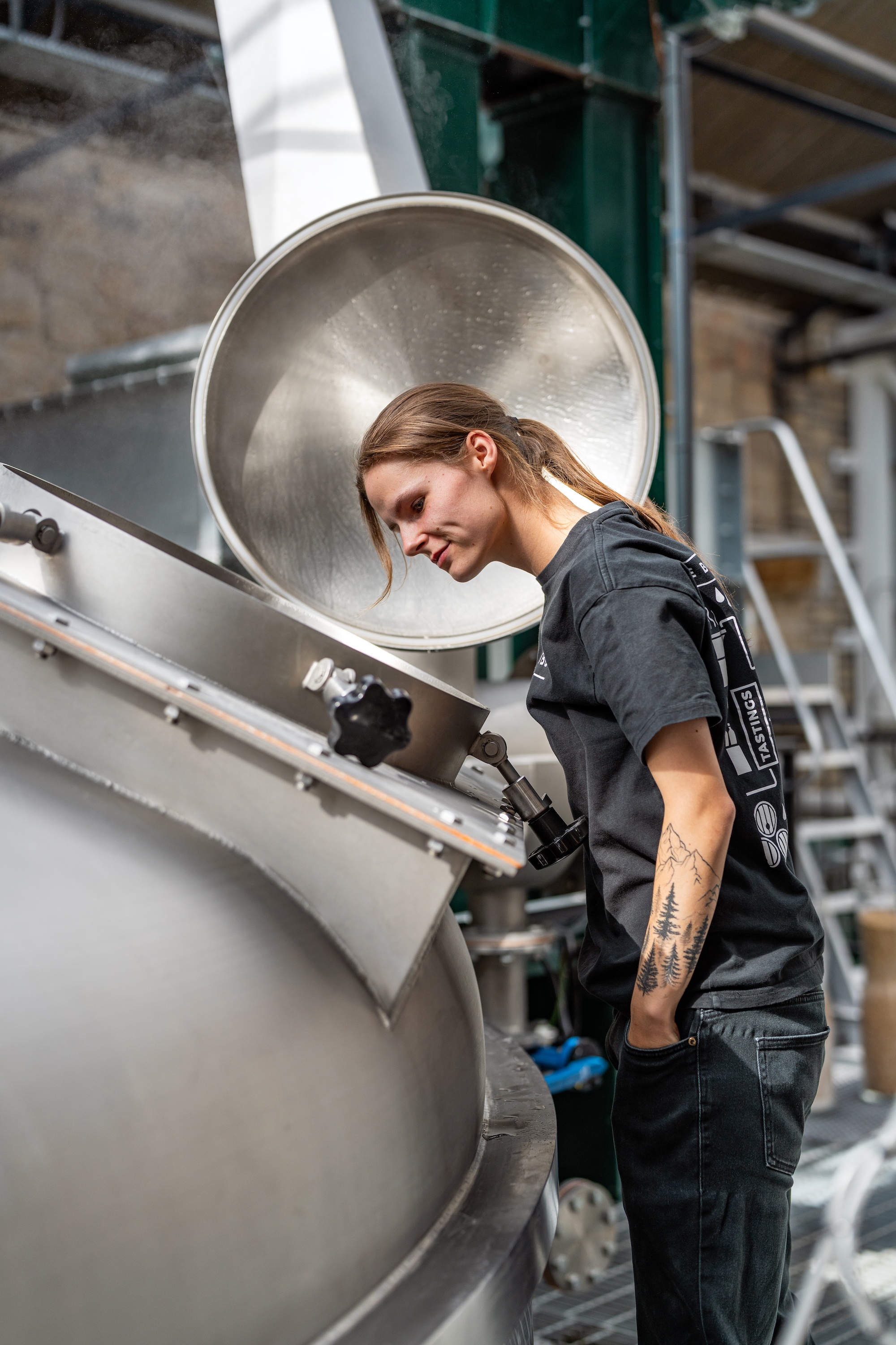 A worker checking a still at Borders Distillery