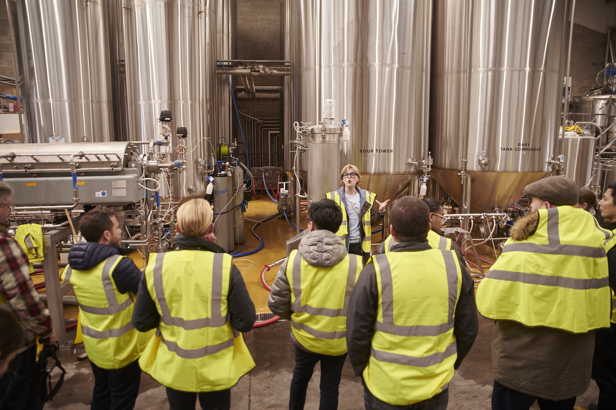 Workers and visitors at a distillery