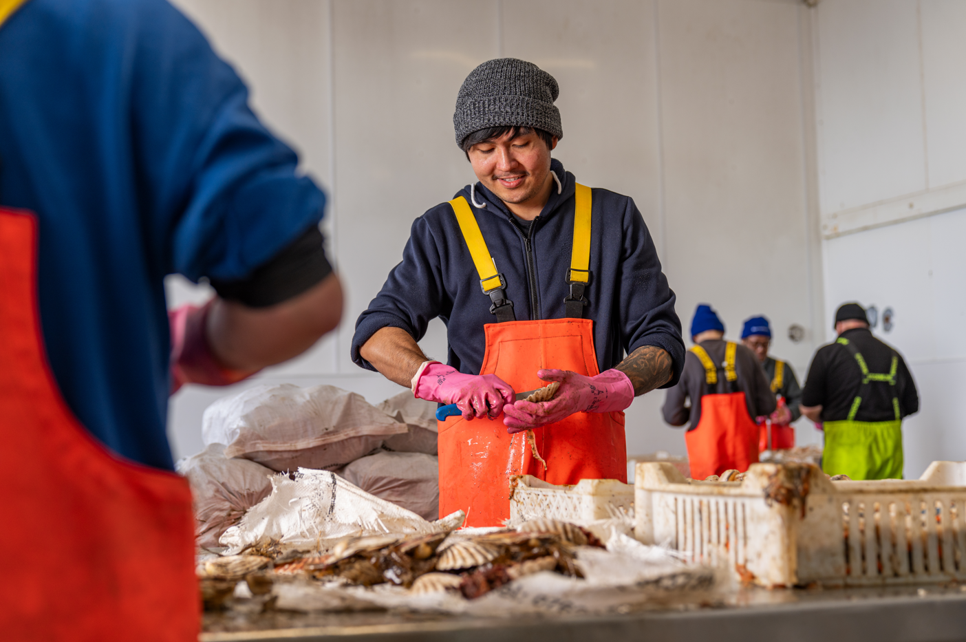 person shucking oysters