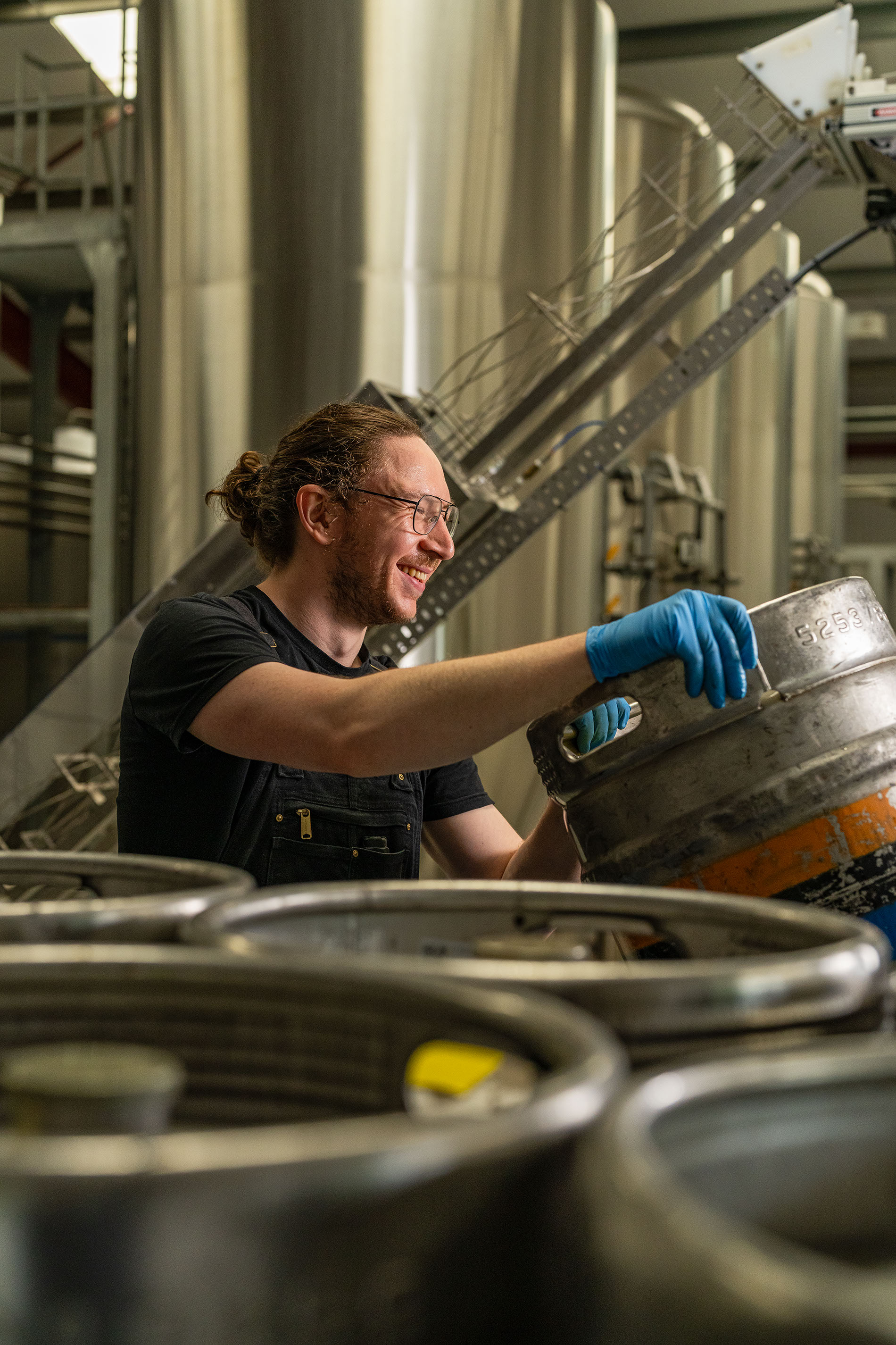 person handling kegs of beer