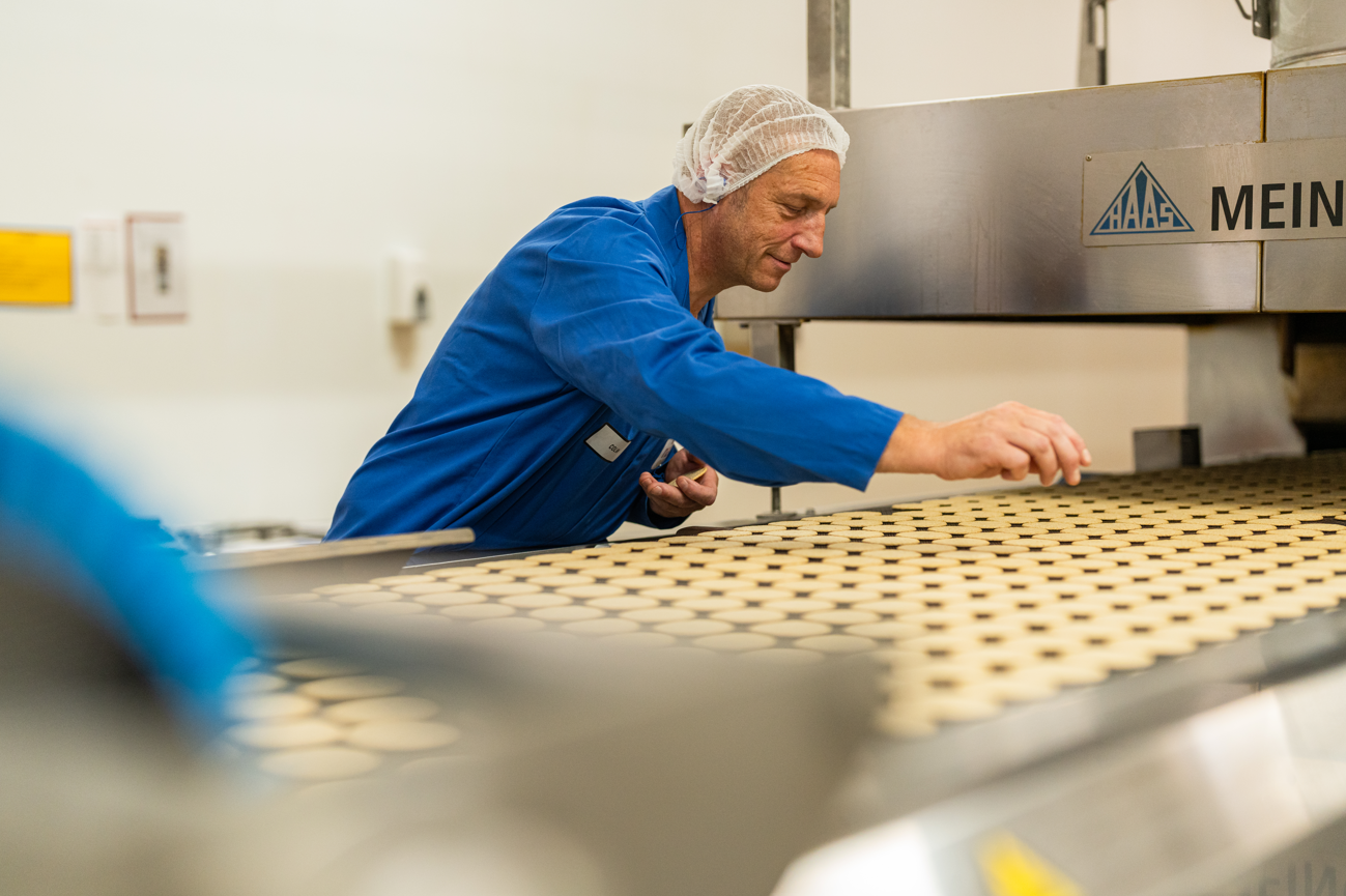 person sorting out oatcakes on a production line