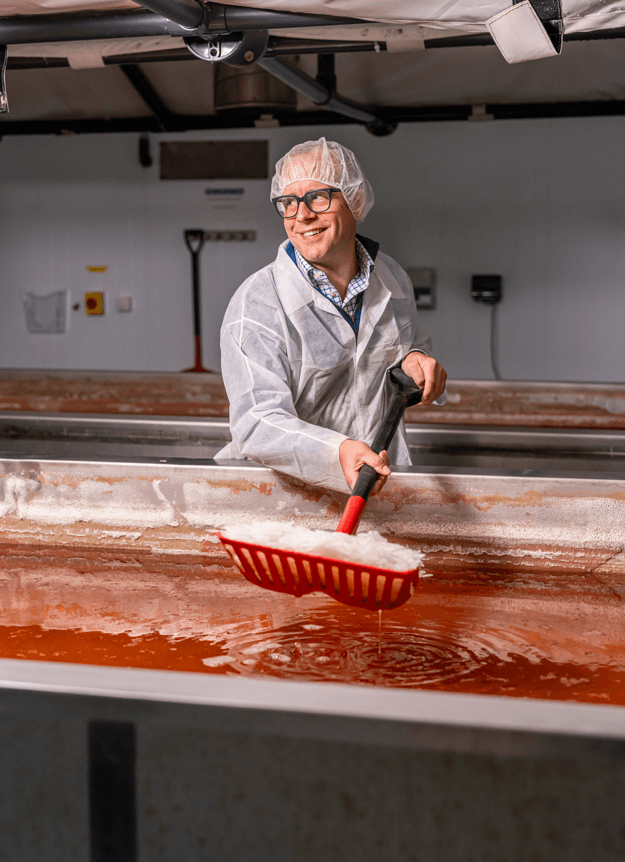 personal scooping salt out of an area in a factory 