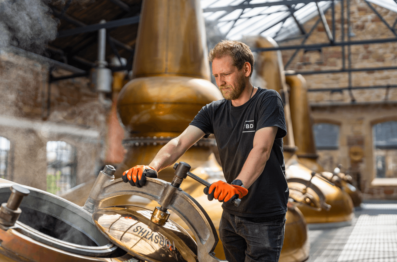 person operating machinery in a distillery